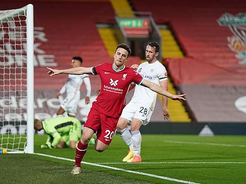 Diogo Jota celebrates after scoring for champions Liverpool against Leicester. The empty galleries may wear a changed look after UK Prime Minister Boris Johnson's decision to allow fans from December.