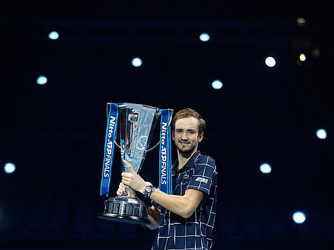Daniil Medvedev of Russia holds up the winners trophy after defeating Dominic Thiem of Austria in the final of the ATP World Finals at the O2 arena in London, Sunday, November 22, 2020.