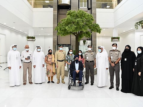 The two sisters with officials and their grandparents after receiving their gold card.