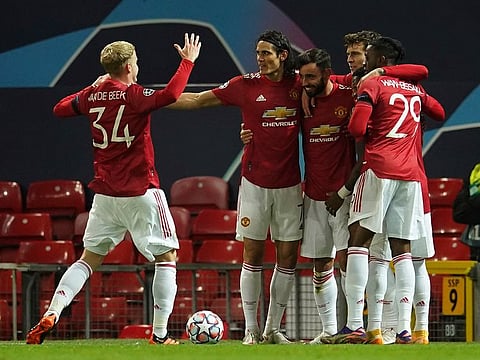 Manchester United's Bruno Fernandes celebrates with team-mates after scoring the opening goal.