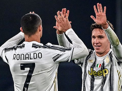 Cristiano Ronaldo and Federico Chiesa (R) celebrate the Juventus victory.