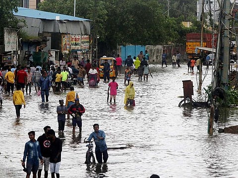 People wade through a flooded street in Chennai, India, Wednesday, Nov.25, 2020. India’s southern state of Tamil Nadu is bracing for Cyclone Nivar that is expected to make landfall on Wednesday.