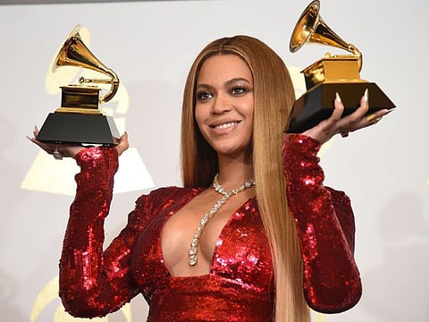 In this file photo singer Beyonce poses with her Grammy trophies in the press room during the 59th Annual Grammy music Awards in Los Angeles, California. Pop queen Beyonce's "Black Is King" musical film propelled her to the front of this year's Grammy pack with nine nominations.