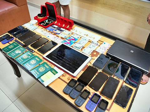 During the raid, police seized 21 mobile phones, tablets and laptops, in addition to bank cards, cash and gold jewellery from the gang members.