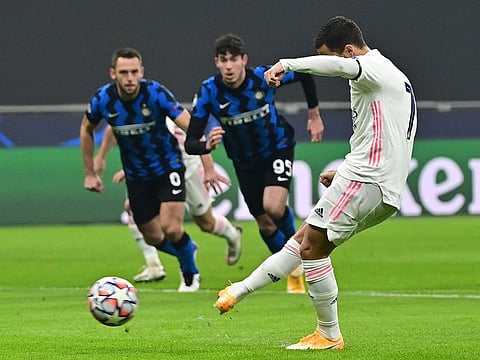 Real Madrid's Belgian forward Eden Hazard scores a penalty against Inter Milan.