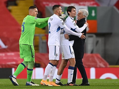 Atalanta's Coach Gian Piero Gasperini (R) celebrates with his players at the end of the victory over Liverpool.