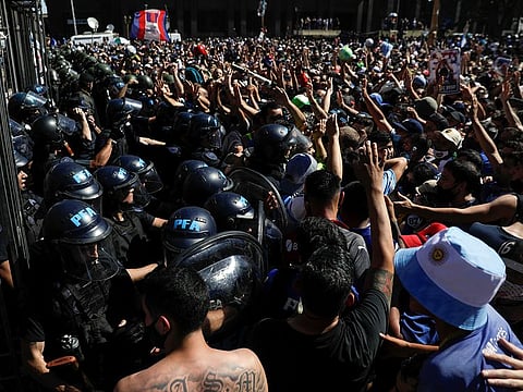 Police try to disperse people gathering in front of the Casa Rosada presidential palace to mourn the death of football legend Diego Maradona, in Buenos Aires, Argentina November 26, 2020.