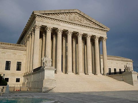 The setting sun shines on the US Supreme Court building in Washington