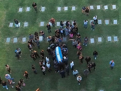 Aerial view of the burial of late Argentine football legend Diego Maradona as his family and friends carry the coffin at the Jardin Bella Vista cemetery, in Buenos Aires province, on November 26, 2020.