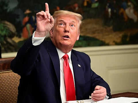US President Donald Trump gestures as he participates in a Thanksgiving video teleconference with members of the military forces at the White House in Washington, U.S., November 26, 2020.