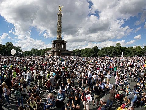 In this August 29, 2020 file photo, people gather at the Victory Column as they attend a protest rally in Berlin, Germany against new coronavirus restrictions in Germany. The country has hit another grim milestone in the coronavirus pandemic ticking above 2 million confirmed cases.
