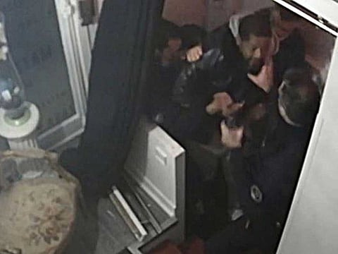 This video grab taken on November 27, 2020 from an AFP video shows CCTV camera footage, widely distributed on social networks, showing producer Michel Zecler being beaten up by police officers at the entrance of a music studio in the 17th arrondissement of Paris on November 21, 2020.