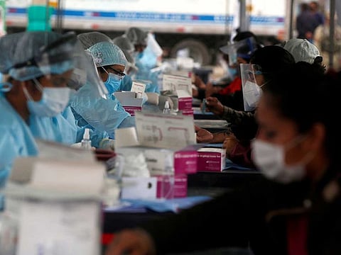 FILE PHOTO: Healthcare workers collect blood samples at a coronavirus disease (COVID-19) testing site in Lima, Peru October 31, 2020.