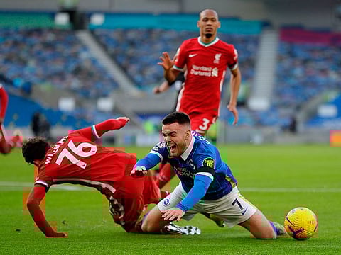 Liverpool's Neco Williams fouls Brighton's Irish striker Aaron Connolly for a penalty