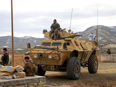 Afghan National Army soldiers keep watch outside of a military compound after a car bomb blast on the outskirts of Ghazni city, Afghanistan November 29, 2020.