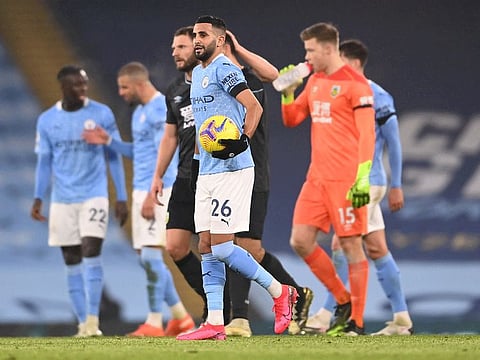 Manchester City's Riyad Mahrez celebrates his hat-trick with the match ball after the match against Burnley on Saturday.