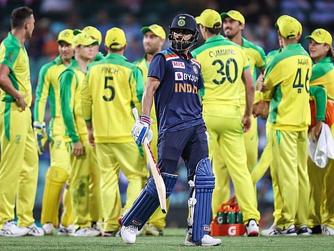 India's captain Virat Kohli (C) reacts as he walks off the ground after being dismissed by Australia's Josh Hazlewood during the second ODI at the Sydney Cricket Ground (SCG) in Sydney on November 29, 2020.