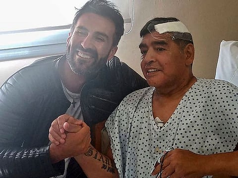 November 11, 2020 file photo: Maradona shaking hands with his doctor Leopoldo Luque (left) in Olivos, Buenos Aires.