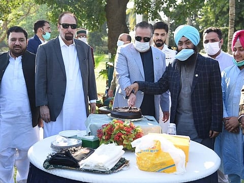 Sindh Governor Imran Ismail cuts a cake at Governor House during celebrations to mark the 551st birthday of Baba Guru Nanak.