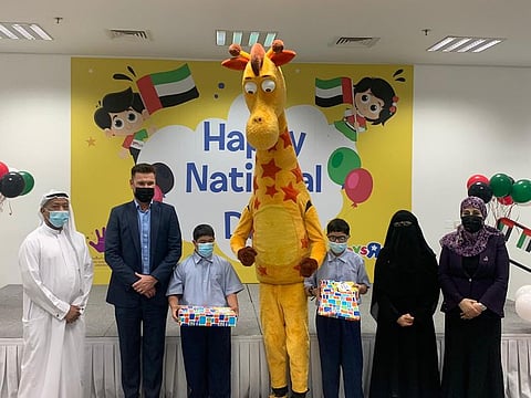 Jonathan Watts with children and management of emirates Down syndrome association