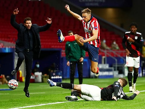 Bayern Munich's Lucas Hernandez in action with Atletico Madrid's Marcos Llorente.