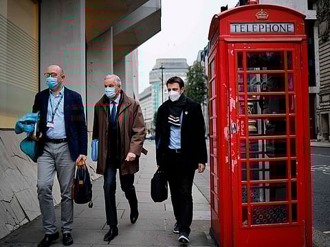 EU chief negotiator Michel Barnier (2L), wearing a protective face covering to combat the spread of the coronavirus, walks back to a conference centre in central London on December 2, 2020 as talks continue on a trade deal between the EU and the UK.