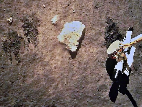 The Chang'e-5 lunar probe gathering samples on the moon.