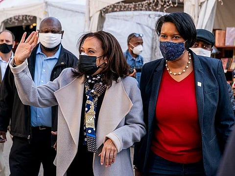 US Vice-President-elect Kamala Harris, centre left, accompanied by Washington Mayor Muriel Bowser, right, waves while visiting the Downtown Holiday Market, Saturday, Nov. 28, 2020, in Washington.