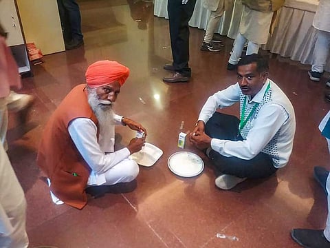 Farmers' representatives, holding talks with the Centre, have their own food during the lunch break, at Vigyan Bhawan in New Delhi, Thursday, Dec. 3, 2020.