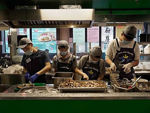 Staff work at Dignity Kitchen in Hong Kong on Nov. 17, 2020. What sets Dignity Kitchen apart from other restaurants in the city is that it is a social enterprise, almost entirely staffed by employees with physical or mental disabilities.