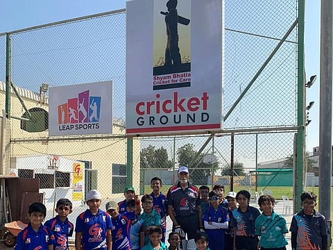 Shyam Bhatia (centre) with trainees of the G-Force Cricket Academy at the re-branded ground at Al Jaddaf area on Friday.