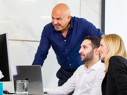 Dariush Soudi (left) with others at his office.