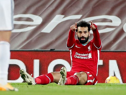 Liverpool's Mohamed Salah, right, celebrates after scoring the opening goal against Wolves.