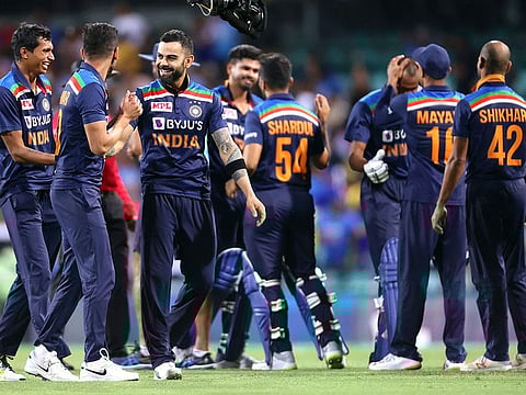 India's captain Virat Kohli (3rd L) celebrates victory against Australia with teammates after the second T20 match at the Sydney Cricket Ground on December 6, 2020.