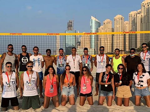 Winners of Sheraton Jumeirah Beach Residence Beach Volleyball event pose one for the album.