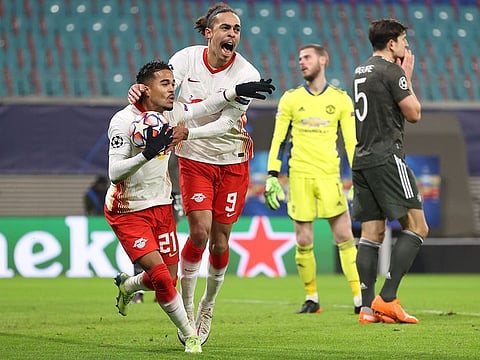Leipzig’s Justin Kluivert, left, celebrates scoring with teammate Yussuf Poulsen during the Champions League