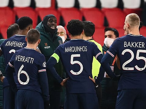 Istanbul Basaksehir's French forward Demba Ba (L) talks to referee after the game was suspended amid allegations of racism by one of the match officials during the UEFA Champions League group H football match between Paris Saint-Germain (PSG) and Istanbul Basaksehir FK at the Parc des Princes stadium in Paris, on December 8, 2020.