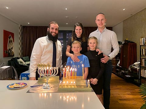 Rabbi Levi Duchman of the United Arab Emirates lighting a Menorah in his home the UAE (December 2019)