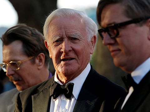 John Le Carre poses for photographers with actor Gary Oldman (L) and director Tomas Alfredson at the UK premiere of Tinker Tailor Soldier Spy in London September 13, 2011.