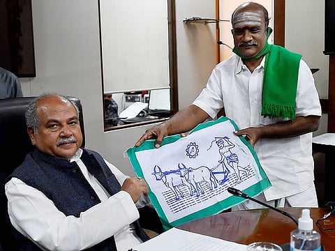 India's Union Agriculture Minister Narendra Singh Tomar (left) with a representative of a farmers' organisation, associated with All India Kisan Coordination committee, during a meeting with farm leaders from 10 states in support of the agri-laws, in New Delhi, on Monday.
