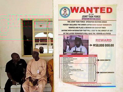 A poster advertising for the search of Boko Haram leader Abubakar Shekau is pasted on a wall in Baga village on the outskirts of Maiduguri, in the north-eastern state of Borno, Nigeria May 13, 2013.