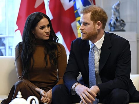 Britain's Prince Harry and Meghan, Duchess of Sussex gesture during their visit to Canada House in thanks for the warm Canadian hospitality and support they received during their recent stay in Canada, in London, Tuesday, Jan. 7, 2020.