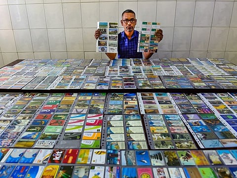 Indian expat Sajid Nottiparambil with his calling card collection
