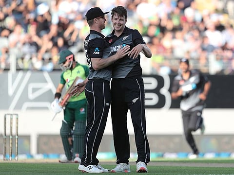 New Zealand’s debutant paceman Jacob Duffy (right) and Jimmy Neesham celebrate the wicket of Pakistan's Mohammad Rizwan during the first T20 International at Eden Park in Auckland on Friday.