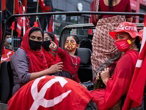 Communist Party of India (Marxist) supporters join a procession to celebrate their win in the local body elections in Kochi, on December 16, 2020.