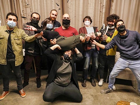 (L-R back row) Stand-up comedians Mario Moubarak, Firas Shamieh, Mohammed Baalbaki, Nicolas Tawk, Iyad Al Hout, Georges, and Georges pose for a picture behind Shaden (on her knees) and Lama Chmayaa (carried), before taking part in a comedy night organised by the "Awk.word" platform ahead of their show at the KED Beirut venue in the Lebanese capital's Karantina neighbourhood on December 15, 2020.