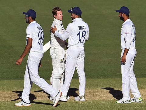Australia's Steve Smith (2nd L) talks with India's Virat Kohli (2nd R) on the third day of the first cricket Test match between them in Adelaide on December 19, 2020.