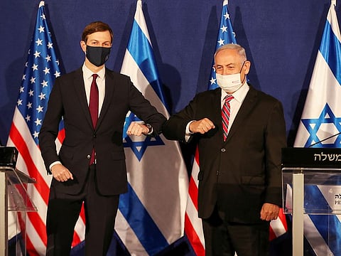 White House senior adviser Jared Kushner elbow bumps Israeli Prime Minister Benjamin Netanyahu, during a news conference in Jerusalem, on December 21, 2020. REUTERS