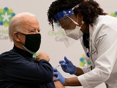 President-elect Joe Biden receives his first dose of the coronavirus vaccine from Nurse partitioner Tabe Mase at Christiana Hospital on live television in Newark Del., Monday, Dec. 21, 2020.