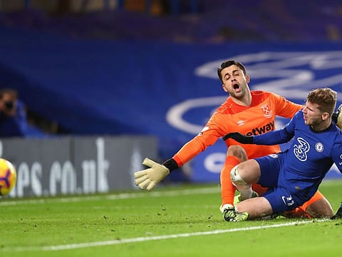 Chelsea's German striker Timo Werner (right) collides with West Ham United goalkeeper Lukasz Fabianski during their English Premier League match on Monday night.